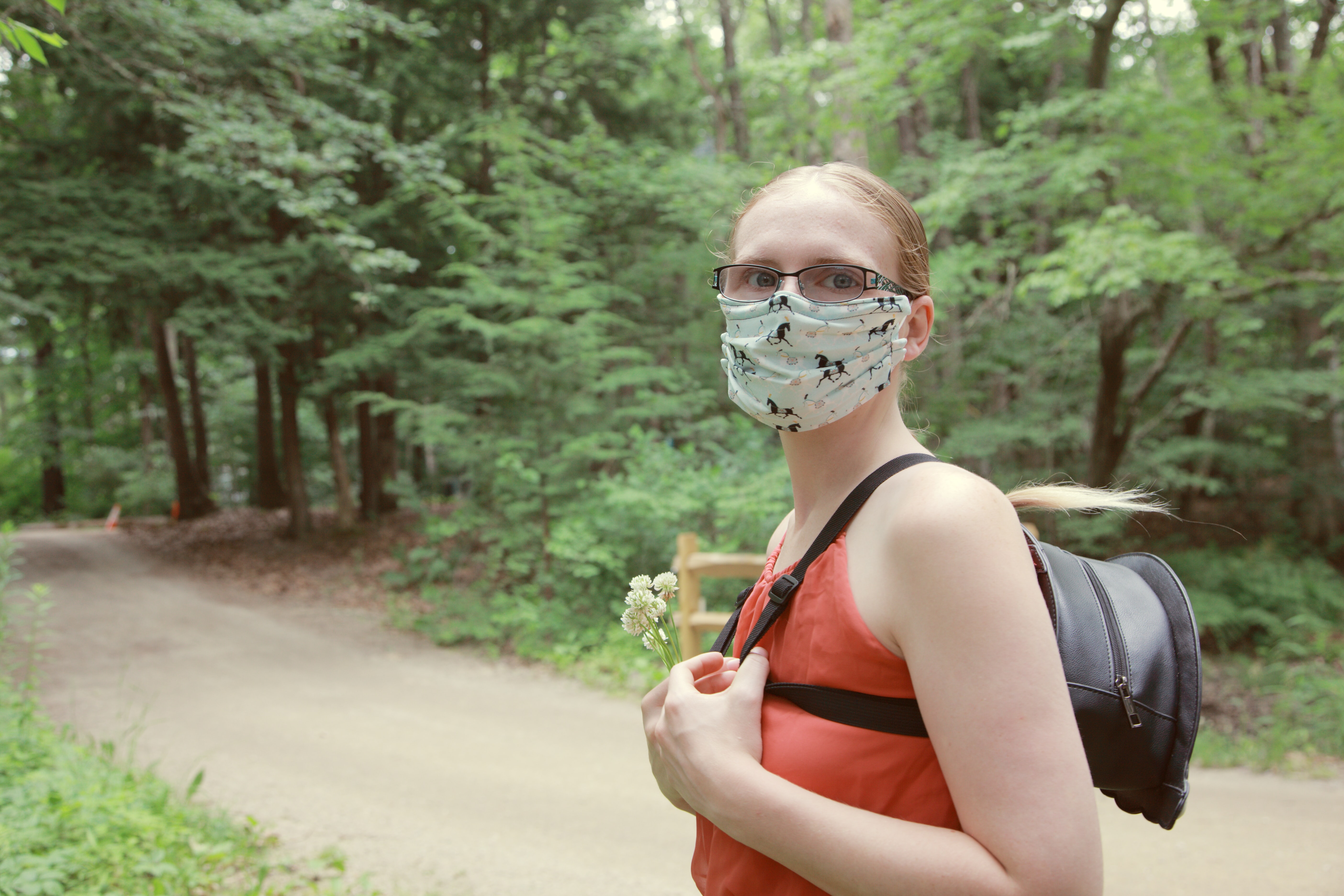 Woman exploring the forest with a mask